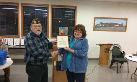Commander Floyd Leach presents certificates of appreciation